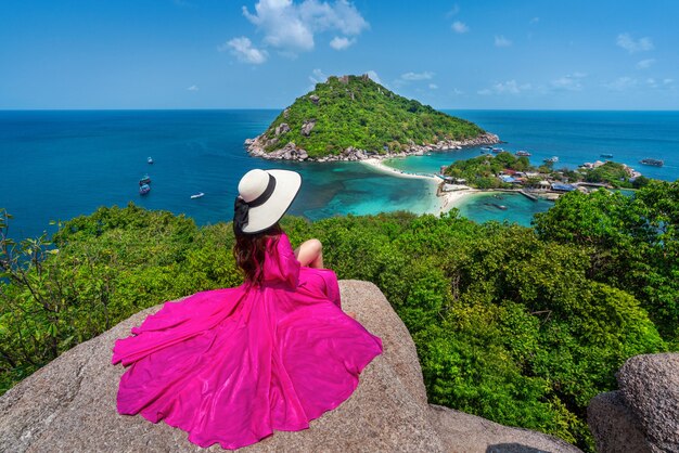 beautiful girl sitting on viewpoint at koh nangyuan island near koh tao island, surat thaini in thailand