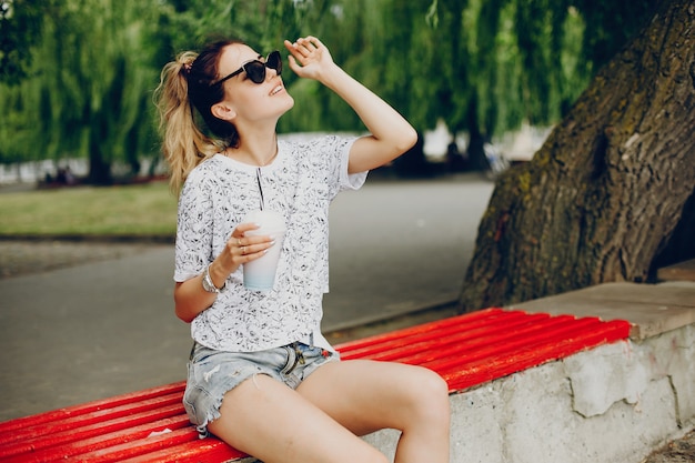 Beautiful girl sitting on the waterfront