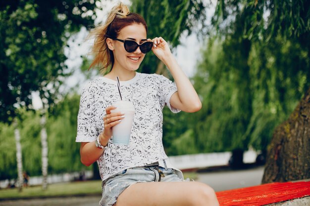 Beautiful girl sitting on the waterfront