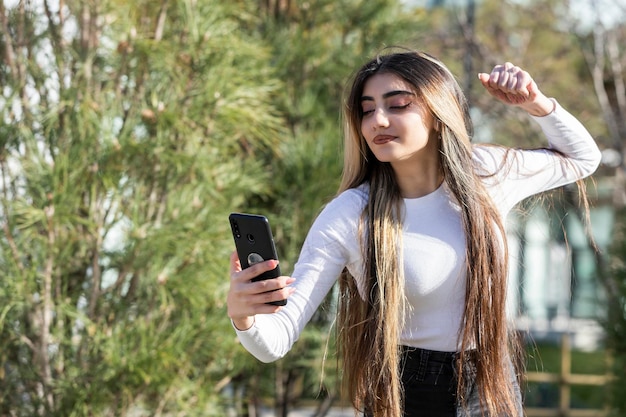 A beautiful girl squeezing her fist and taking selfie High quality photo