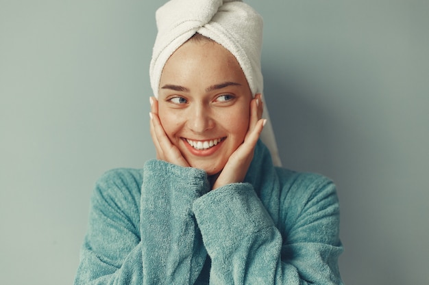 Beautiful girl standing  in a blue bathrobe