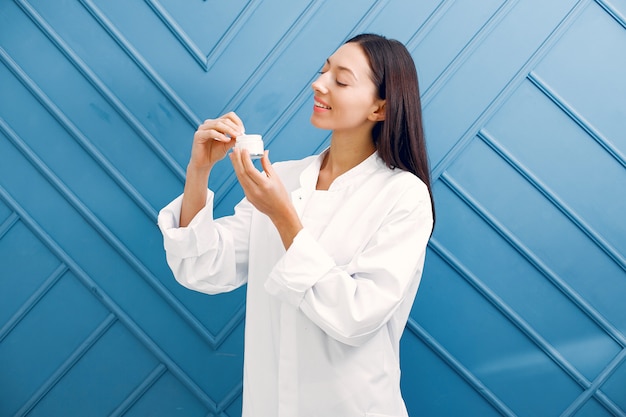 Beautiful girl standing in a studio with cream