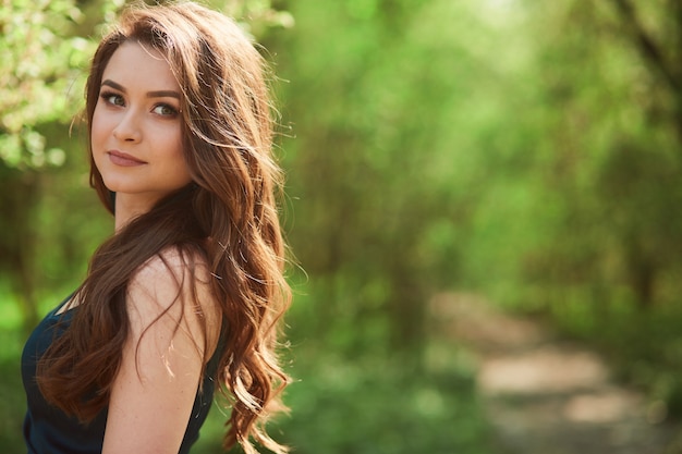 The beautiful girl stands in the park