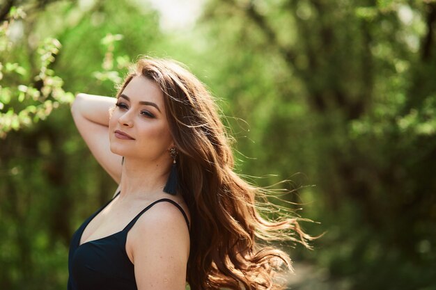 The beautiful girl stands in the park