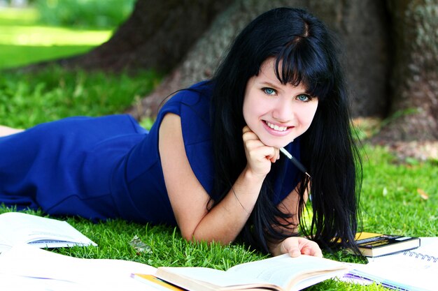 Beautiful girl studying in park