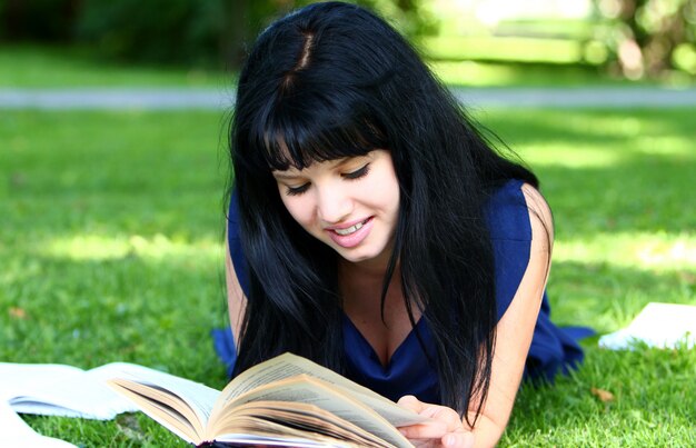 Beautiful girl studying in park