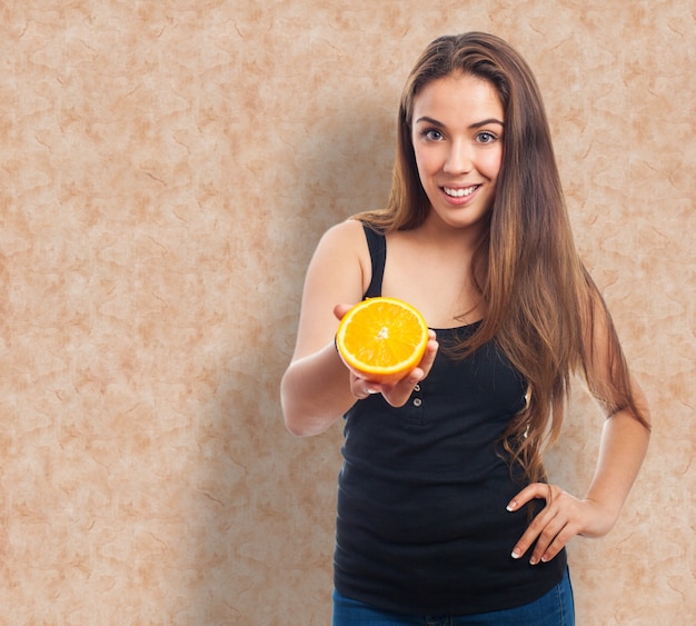 Free photo beautiful girl suggesting orange