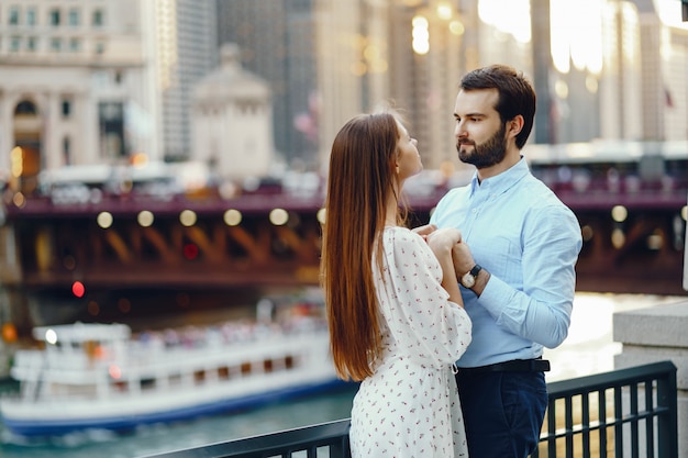 beautiful girl in summer dress with her handsome husband in white shirt and pants