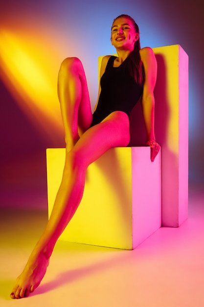 Free photo beautiful girl in swimsuit on neon studio background