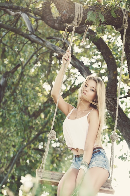 Free photo beautiful girl on a swing