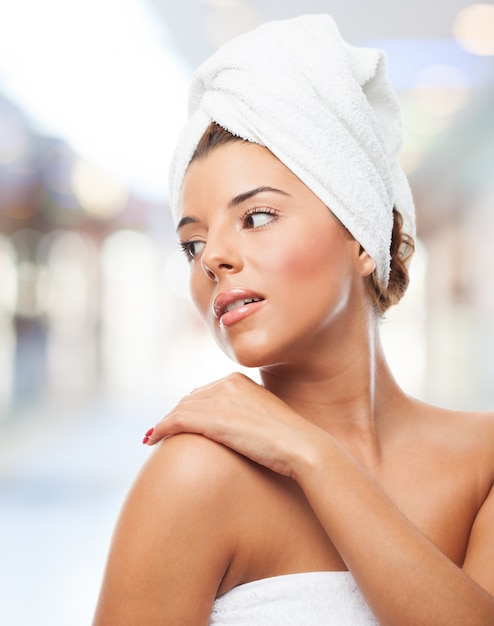 beautiful girl in towel touching shoulder