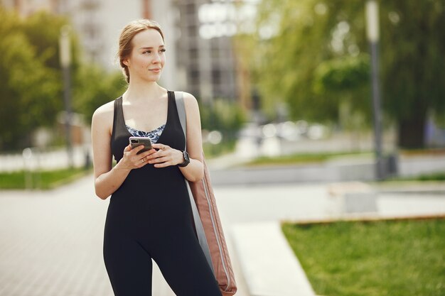 Beautiful girl training. Sports girl in a sportswear. Woman by the water.