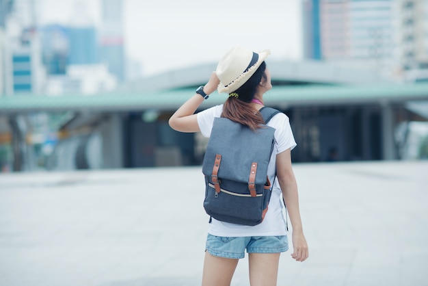 Beautiful girl walking on the city street. Travelling in Thailand