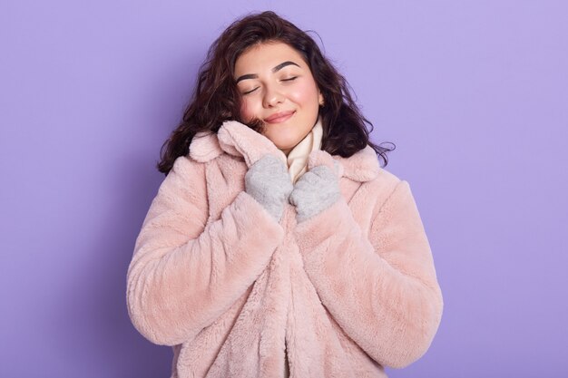 Beautiful girl wearing pale pink faux fur coat