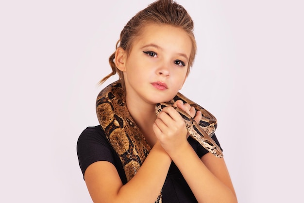 白い​背景​の​上​の​彼女​の​体​に​ヘビ​を​持つ​美しい​少女
