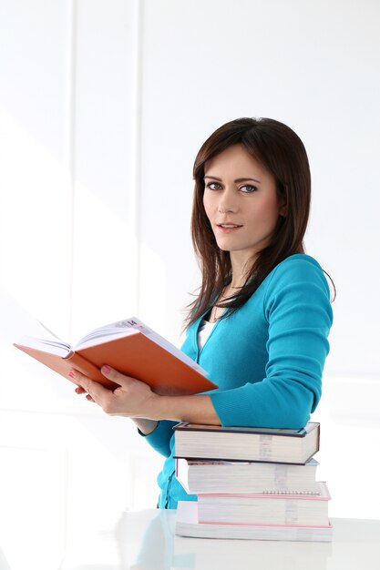 Beautiful girl with blue t-shirt and books