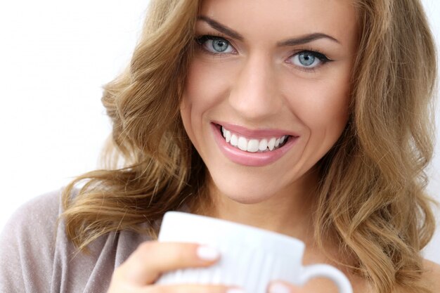 Beautiful girl with cup of tea