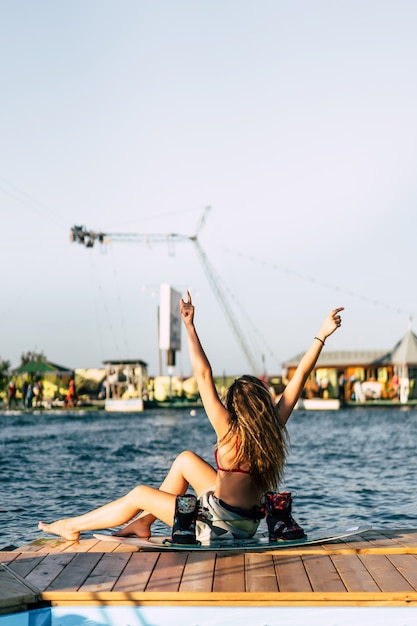 beautiful girl with long hair with a wakeboard