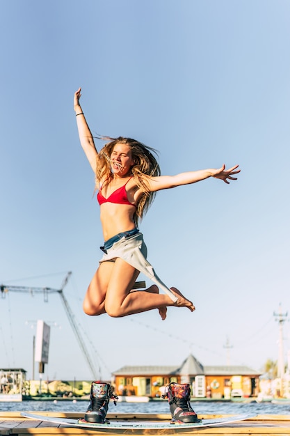 beautiful girl with long hair with a wakeboard