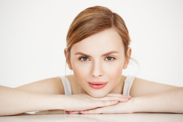 Beautiful girl with perfect clean skin smiling sitting at table . beauty spa and cosmetology.