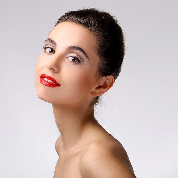 Beautiful girl with perfect skin and red lipstick