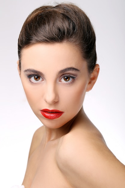 Beautiful girl with perfect skin and red lipstick