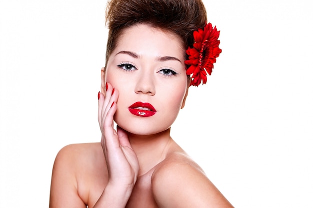 beautiful girl with red lips flower on her hair