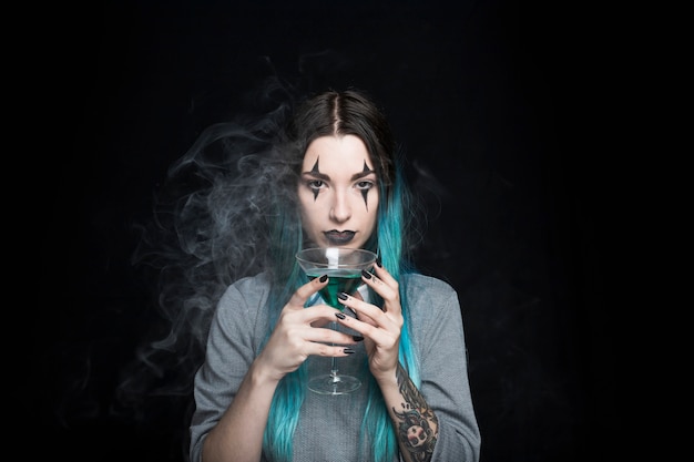 Beautiful girl with wineglass in smoke