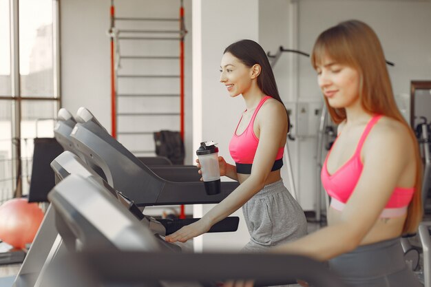 A beautiful girls in a gym on a racetrack