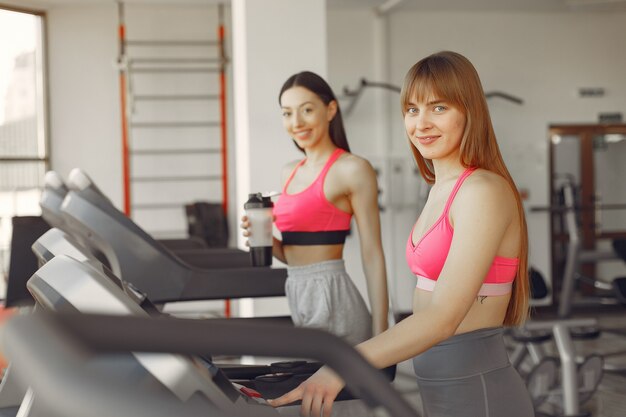 A beautiful girls in a gym on a racetrack