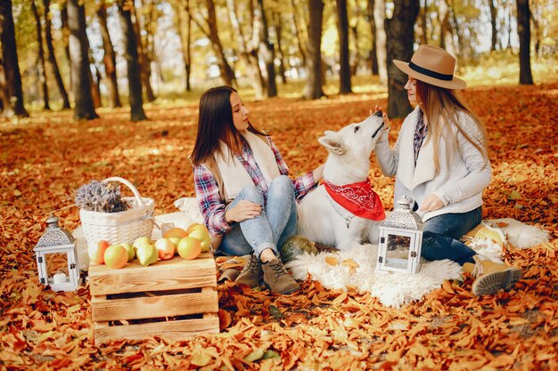 Beautiful girls have fun in a autumn park