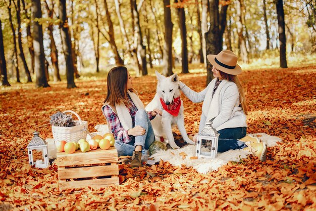 Beautiful girls have fun in a autumn park