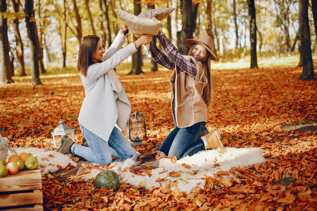 Beautiful girls have fun in a autumn park