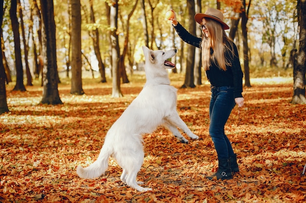 Beautiful girls have fun in a autumn park