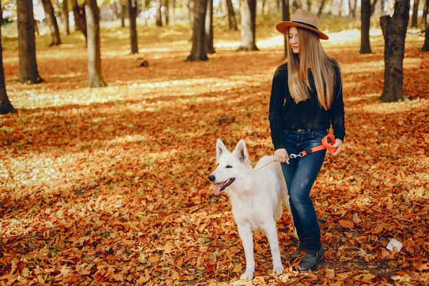 Beautiful girls have fun in a autumn park