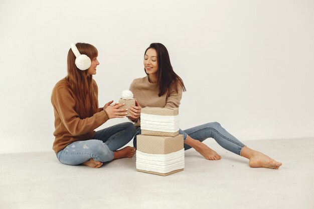 Beautiful girls have fun in a studio with presents