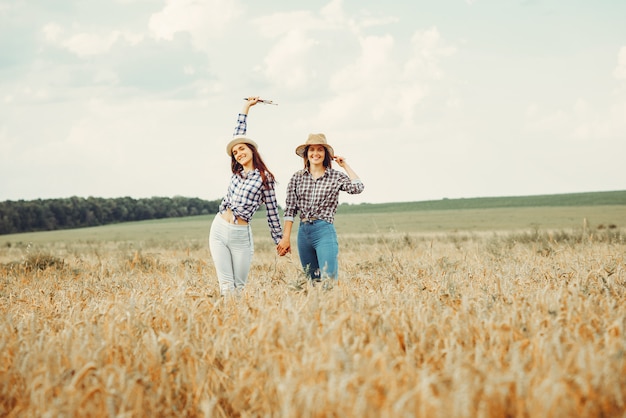 Beautiful girls have a rest in a field