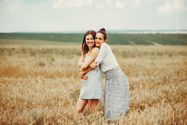 Beautiful girls have a rest in a field