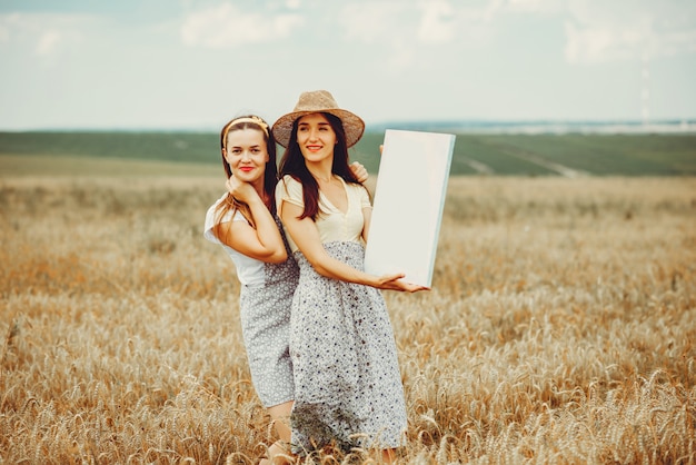 Beautiful girls have a rest in a field