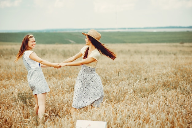 Beautiful girls have a rest in a field