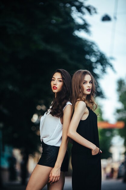 Beautiful girls posing in the city on the street