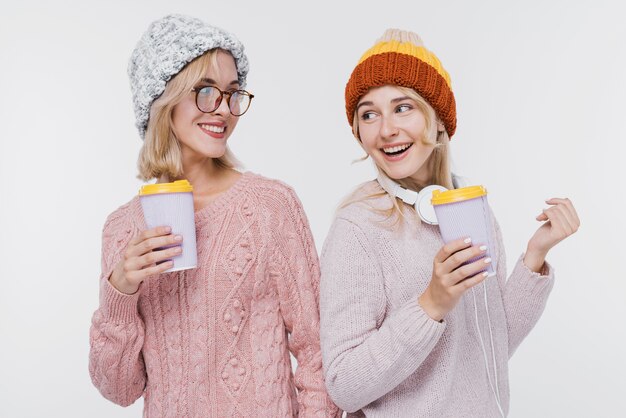 Beautiful girls together in winter clothes