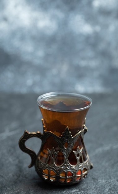 A beautiful glass cup with aroma tea . 