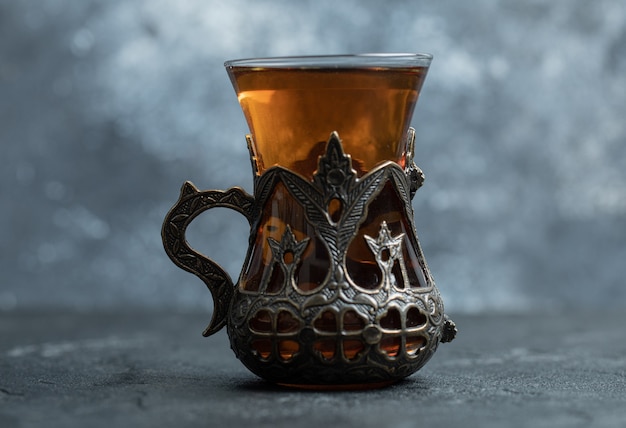 A beautiful glass cup with aroma tea . 