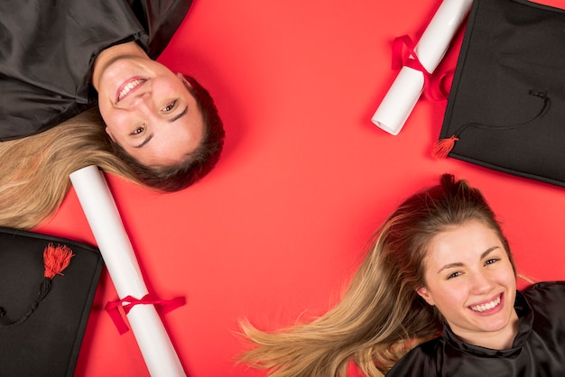 Beautiful graduates with red background