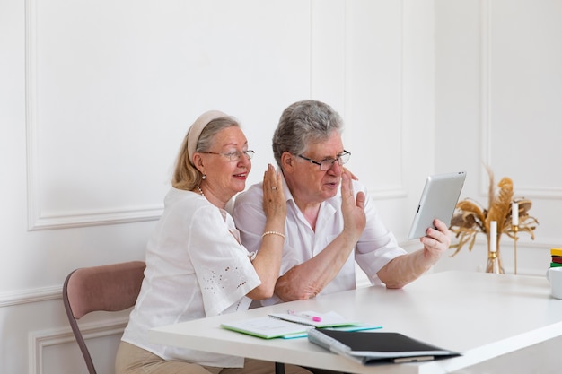 Beautiful grandparents couple learning to use digital device