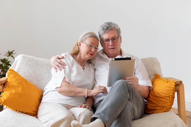 Beautiful grandparents couple learning to use digital device