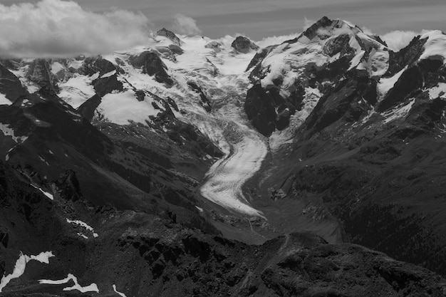 Beautiful grayscale shot of snowy rocky mountains