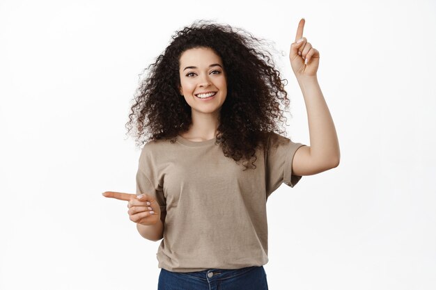 Beautiful happy brunette curly woman on white