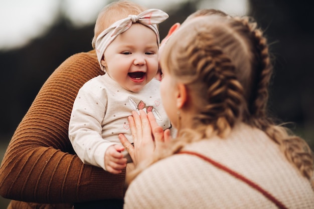 Beautiful and happy family with little child in park